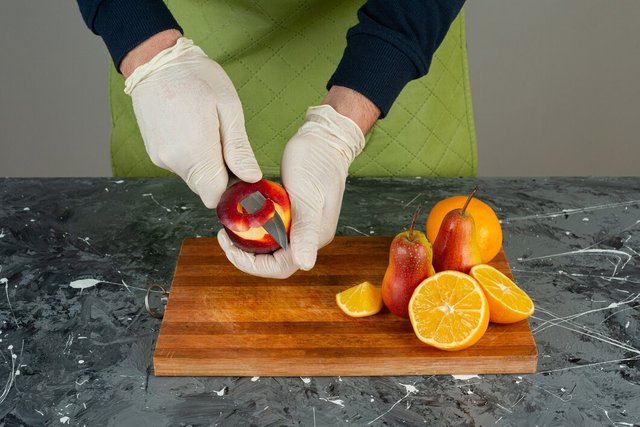 male-hand-peeling-red-apple-top-wooden-board-table_2831-7921.jpg