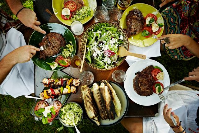 overhead-view-of-friends-dining-at-table-outdoors-126364029-572baf645f9b58c34c6d662a.jpg