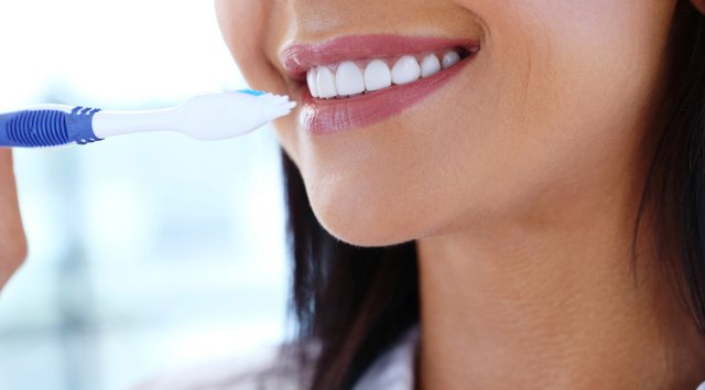 woman-using-toothbrush.jpg