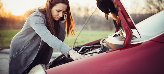 Woman-Standing-Over-Broken-Down-Car-1617128540853.jpg