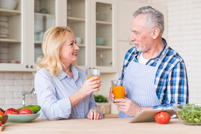 senior-couple-holding-glass-juice-looking-each-other-kitchen_23-2148128089.jpg