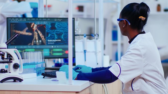 african-woman-biochemist-researcher-checking-manifestations-vaccine-working-modern-equipped-laboratory-multiethnic-doctors-examining-virus-evolution-using-high-tech-researching-diagnosis (1).jpg