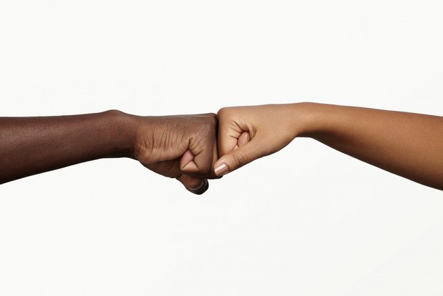 african-man-touching-knuckles-with-dark-skinned-woman-as-sign-agreement-partnership-cooperation.jpg