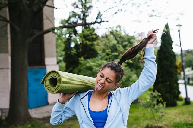 young-woman-walking-urban-park-holding-fitness-rug_1153-6147.jpg