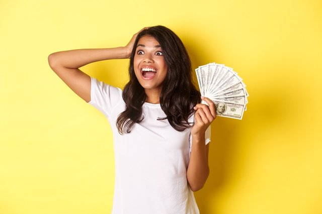 image-lucky-africanamerican-girl-looking-excited-upper-left-corner-holding-money_1258-54929 (1).jpg