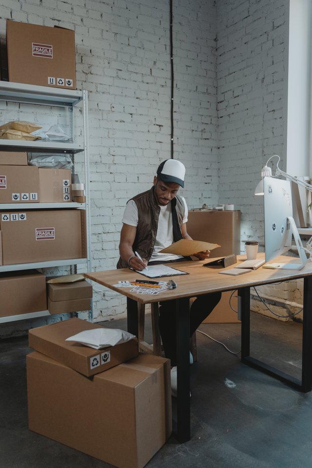 black worker writing at workdesk.jpg