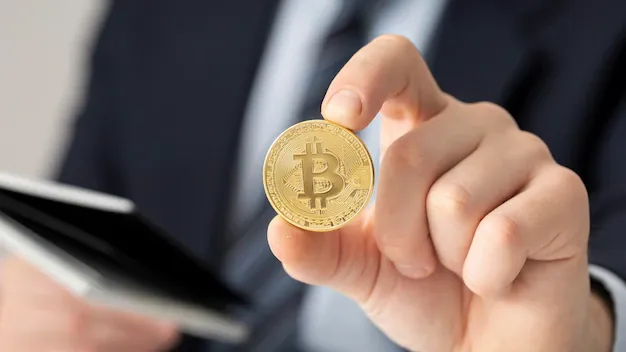 businessman-holding-bitcoin-close-up_23-2148793761.webp