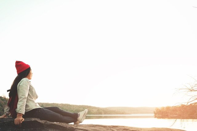 side-view-young-woman-sitting-shore-against-clear-sky_1048944-12552919.jpg