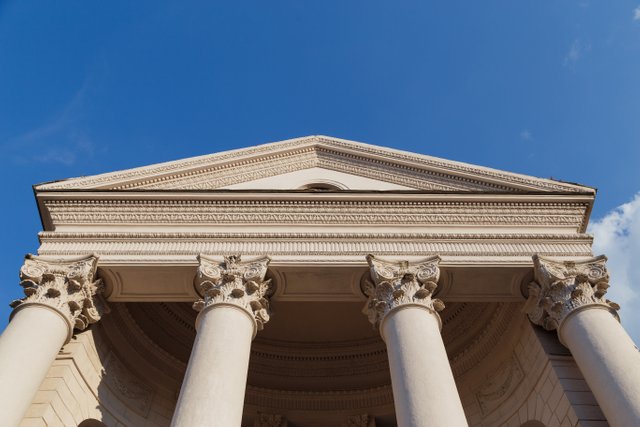 capitol-facade-with-columns-blue-sky-background-bottom-view.jpg