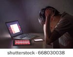stock-photo-young-asian-male-frustrated-confused-and-headache-by-wannacry-ransomware-attack-on-desktop-screen-668030038.jpg