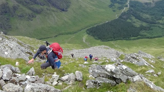 22 Another good vertiginous one of Ian and others clambering up the steep rocky hillside.jpg