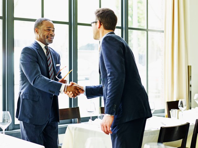 two-businessmen-shaking-hands-at-lunch-meeting-493585563-57717b175f9b585875c2d789.jpg