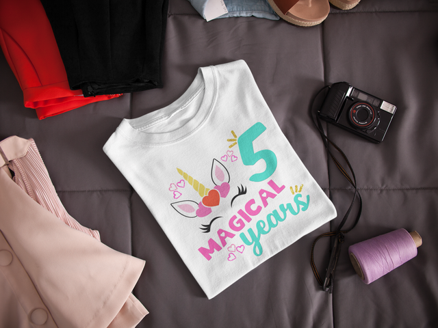 folded-t-shirt-mockup-lying-next-to-a-camera-and-clothes-on-a-bed-a16941 (1).png