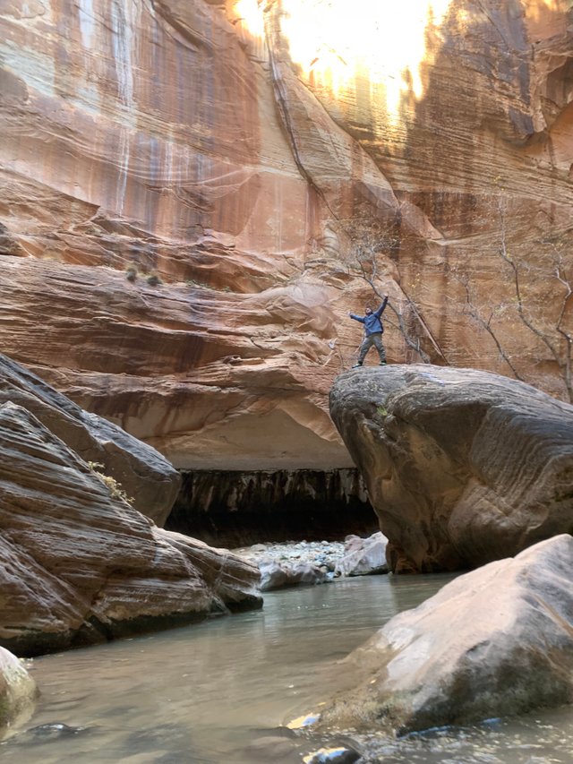 standing on rock w: hands up.JPG