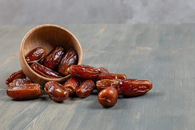 sweet-dates-out-wooden-bowl-marble-surface_114579-73230.webp