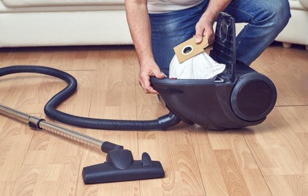 man-taking-out-a-full-dust-bag-from-a-vacuum-cleaner.jpg