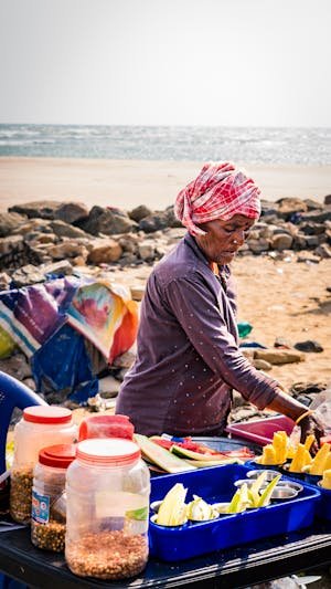 free-photo-of-elderly-woman-selling-food-on-a-beach.jpeg