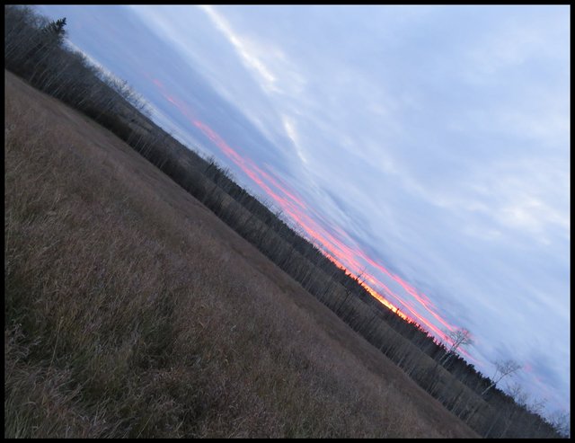 expansive sky with the setting sun on cloud formations.JPG