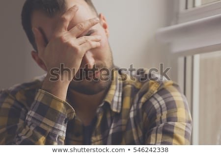 handsome-depressed-man-near-window-450w-546242338.jpg