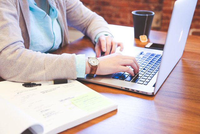 Sitting-on-Desk-and-Working-on-Computer.jpg