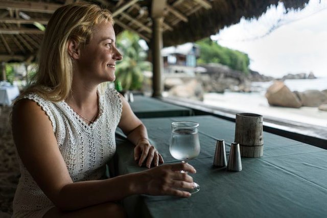 young-smiling-woman-enjoying-in-a-glass-of-cold-water-522851316-572bb8095f9b58c34c71b4d3.jpg