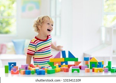 kid-playing-colorful-toy-blocks-260nw-1315411109.jpg