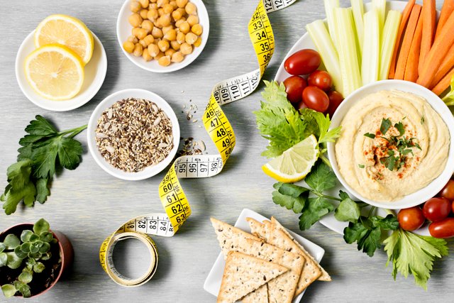 top-view-hummus-with-assortment-vegetables-measuring-tape.jpg