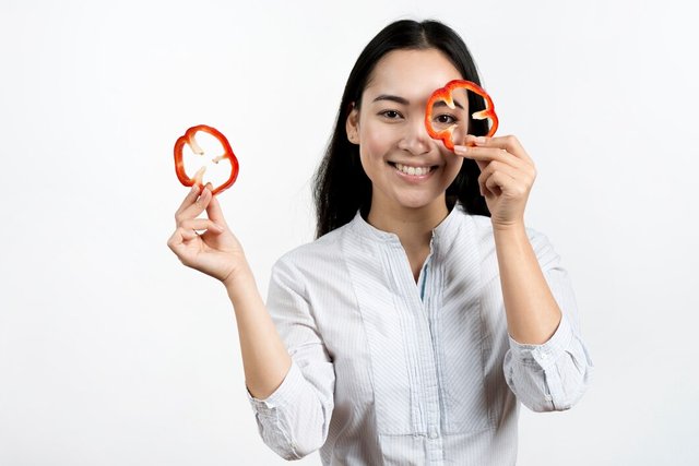 young-woman-making-funny-face-with-red-bell-pepper-slices-white-background_23-2148076211.jpg