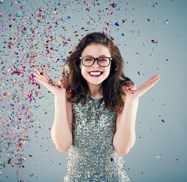 toss-some-confetti-air-celebrate-studio-shot-young-woman-with-confetti-falling-around-her-against-grey-background_590464-20182.jpg