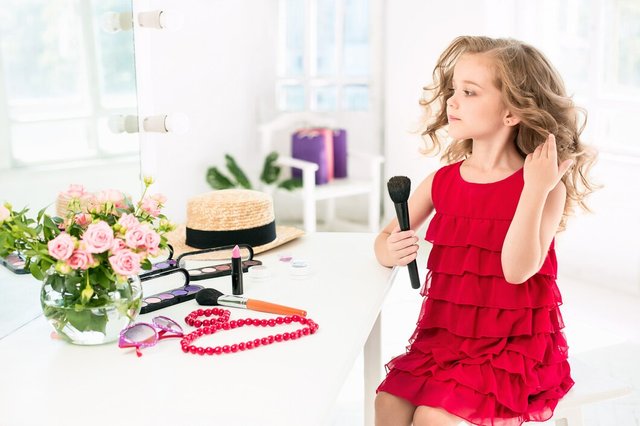 little-girl-with-cosmetics-sitting-near-mirror_155003-2386.jpg