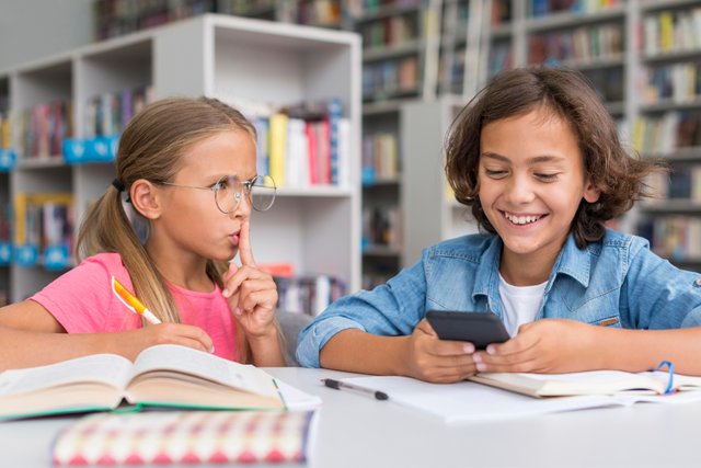 girl-shushing-boy-library.jpg