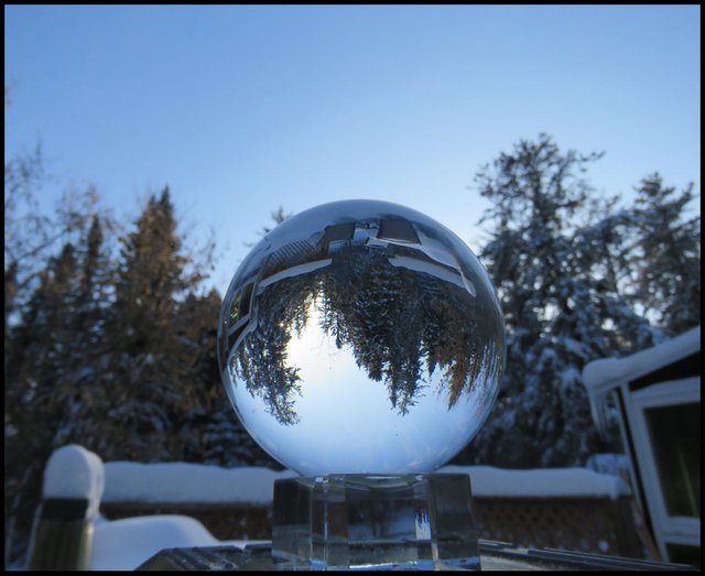 Snowy scene on deck reflected in crystal globe.JPG