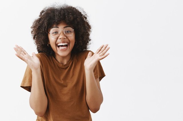 surprised-playful-touched-good-looking-african-american-woman-glasses-stylish-brown-t-shirt-clasping-hands-smiling-from-joy-excitement-liking-great-show_176420-23322.jpg