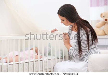 stock-photo-mother-lulling-baby-in-crib-at-home-729783994.jpg