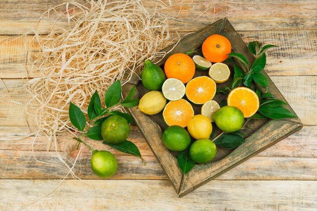 some-citrus-fruits-bronze-plate-wooden-board_176474-28097.jpg