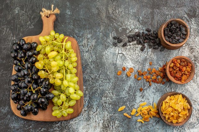 fruits-colorful-dried-fruits-green-black-grapes-cutting-board_140725-120023.jpg