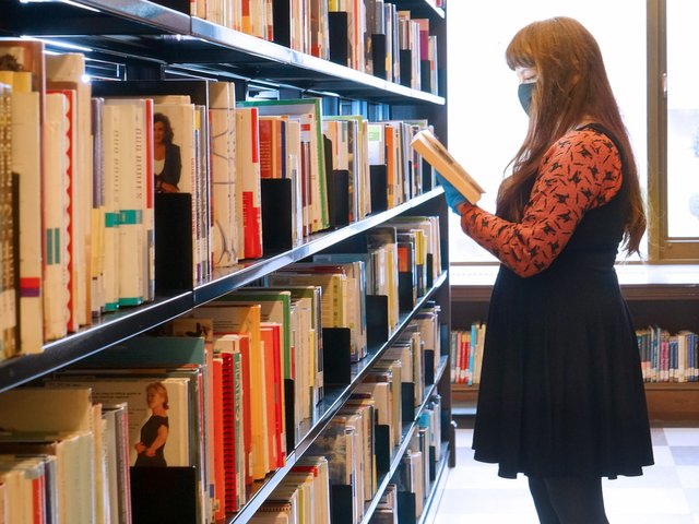 hero-masks-on-browsing-reopen-looking-at-book.jpg