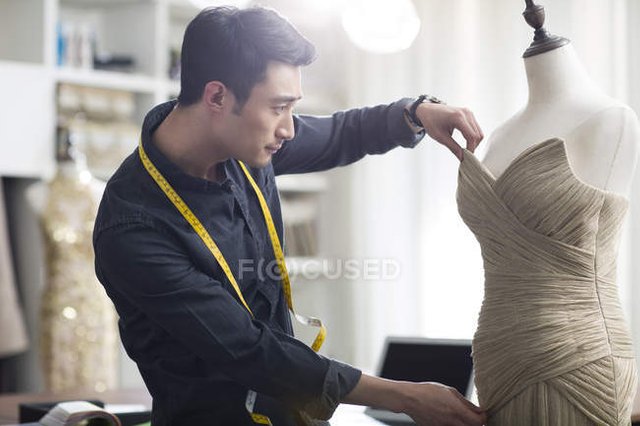 focused_178412790-Male-asian-fashion-designer-working.jpg