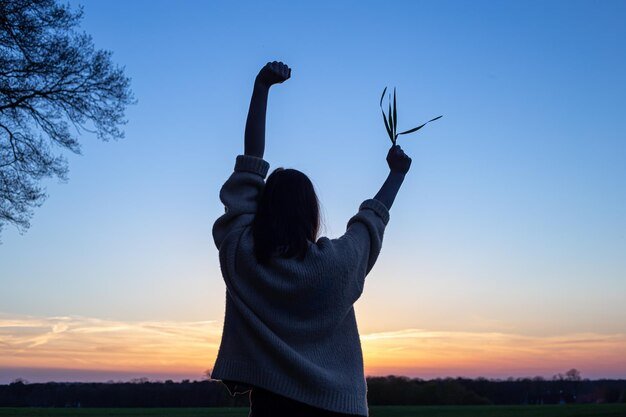 silhouette-woman-sunset-field-against-sky-rear-view_169016-20560.jpg