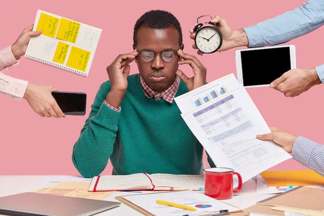 african-american-man-sitting-desk-surrounded-with-gadgets-papers_273609-41520.webp