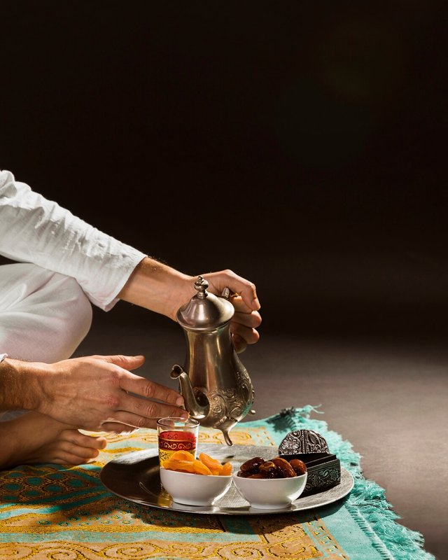 man-white-pouring-tea-tiny-cup-front-view_23-2148444082.jpg