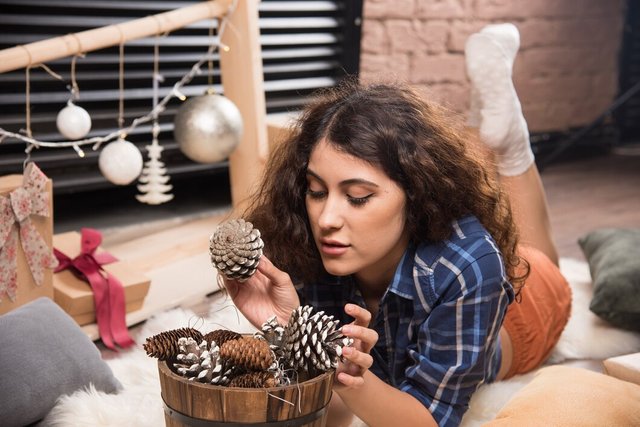 portrait-cute-young-woman-looking-wooden-basket-pinecones_114579-80449.jpg