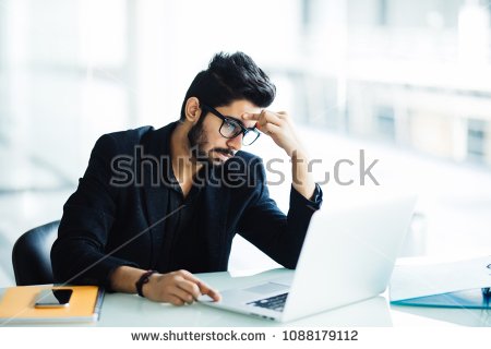 stock-photo-photo-of-an-indian-male-frustrated-with-work-sitting-in-front-of-a-laptop-1088179112.jpg