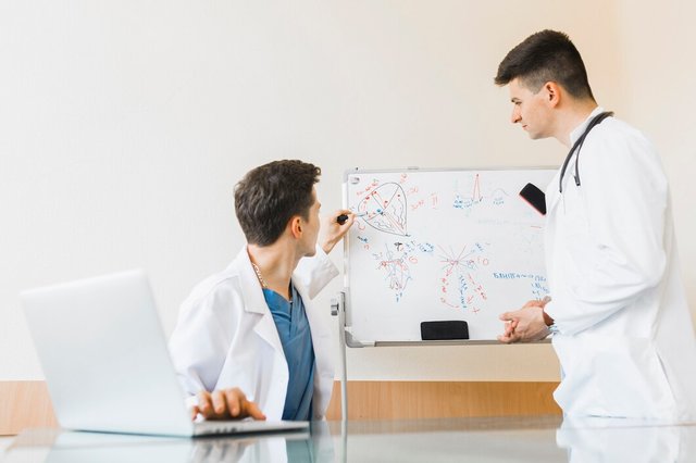 doctors-with-laptop-whiteboard_23-2147822737.jpg