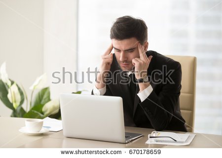 stock-photo-serious-frustrated-businessman-with-closed-eyes-suffering-from-headache-migraine-at-workplace-670178659.jpg