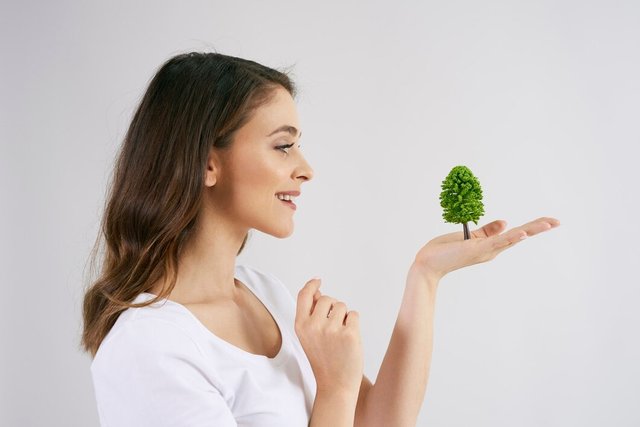 woman-holding-growing-tree-her-hand_329181-20916.jpg