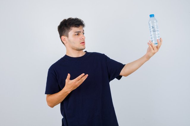 young-man-showing-bottle-water-black-t-shirt-looking-puzzled-front-view_176474-65068.jpg