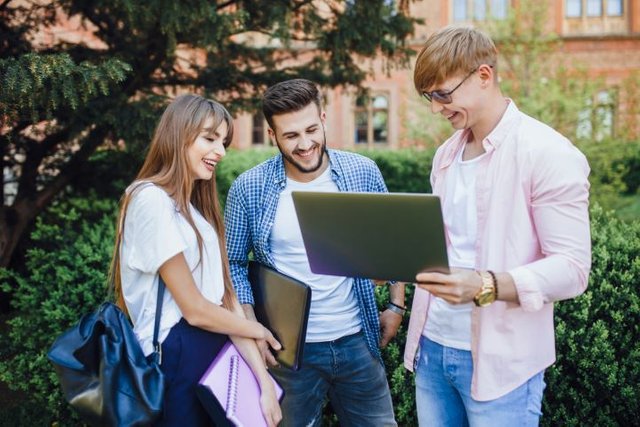 three-students-stylish-clothes-look-laptop-laugh-university-campus1.jpg