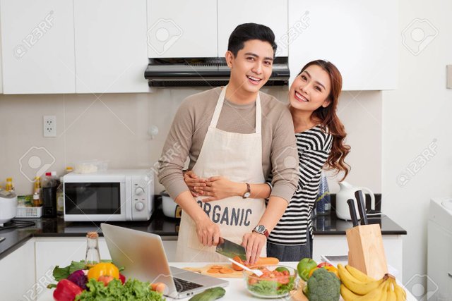 107461908-loving-couple-cooking-together-in-the-kitchen-at-home.jpg