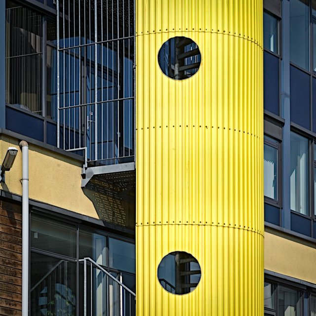Yellow stair tower of an apartment building